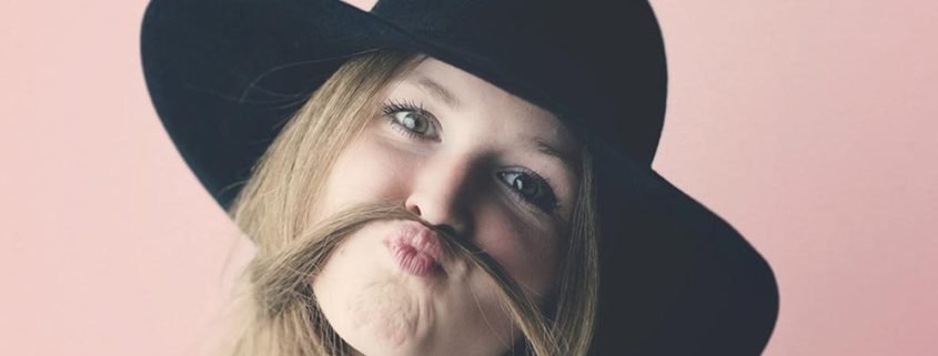 Girl making a funny face with a hat on